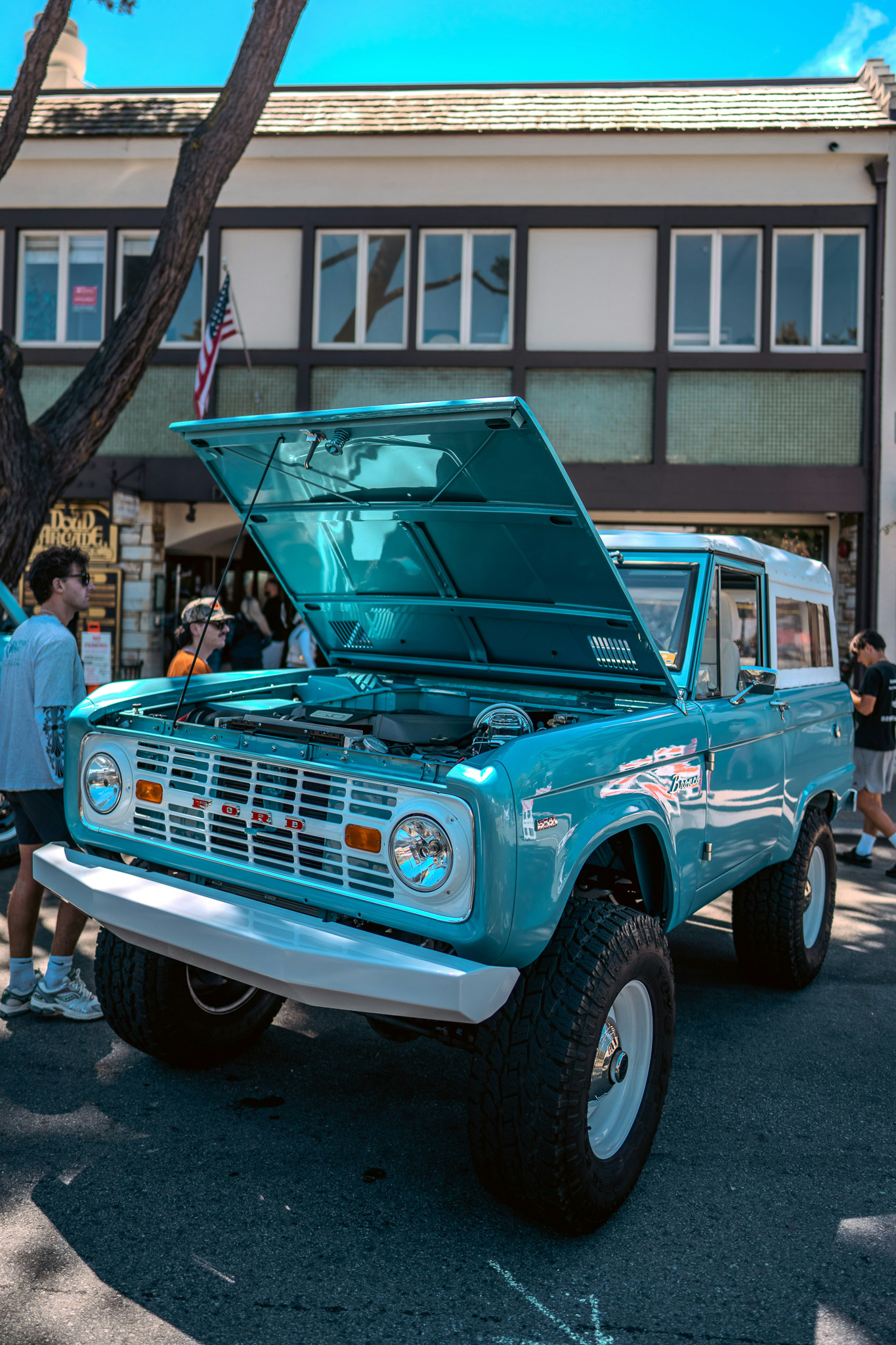 Image of a bright blue Ford Bronco with the hood propped open.