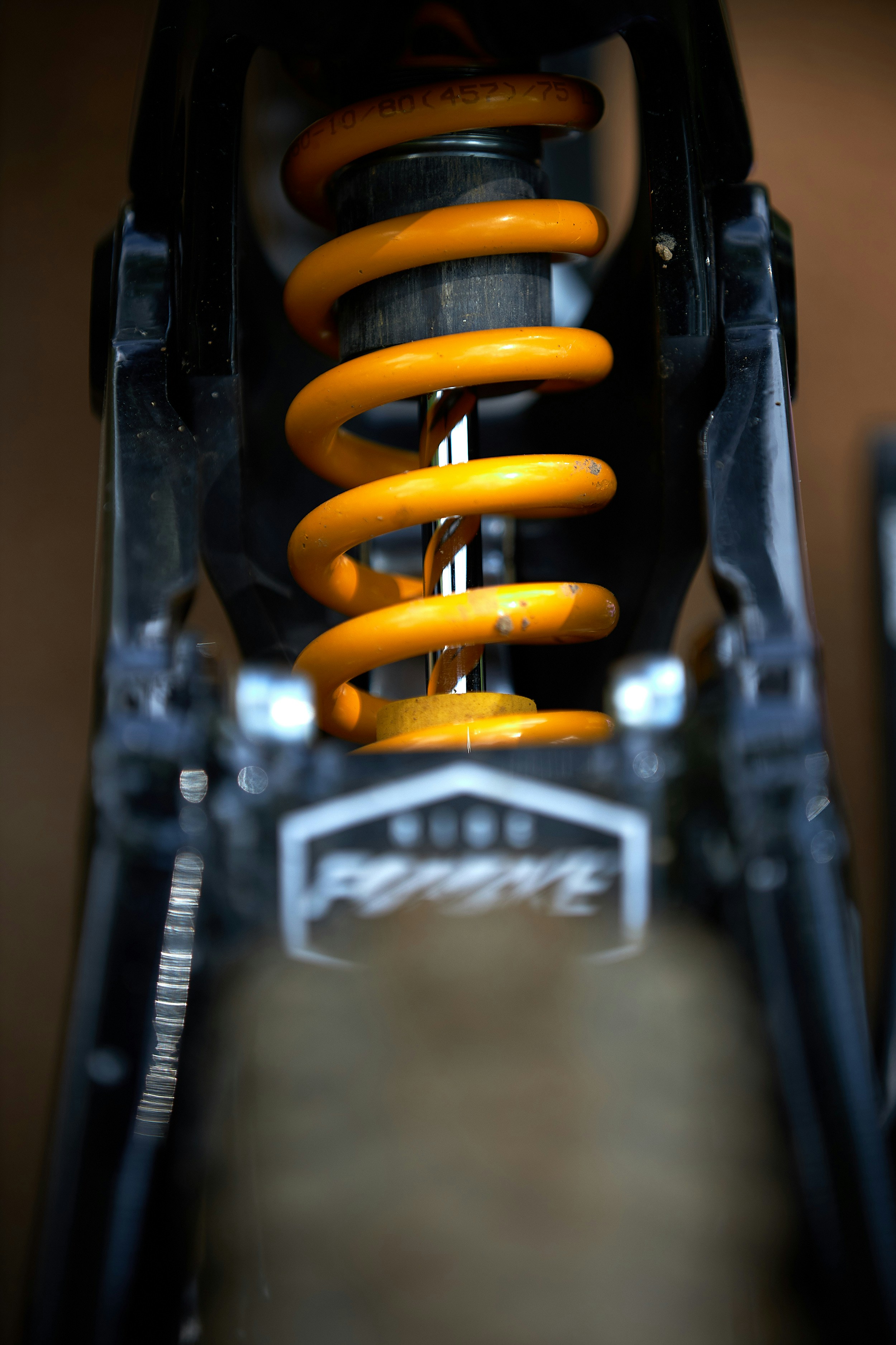 Image of yellow car suspension system.